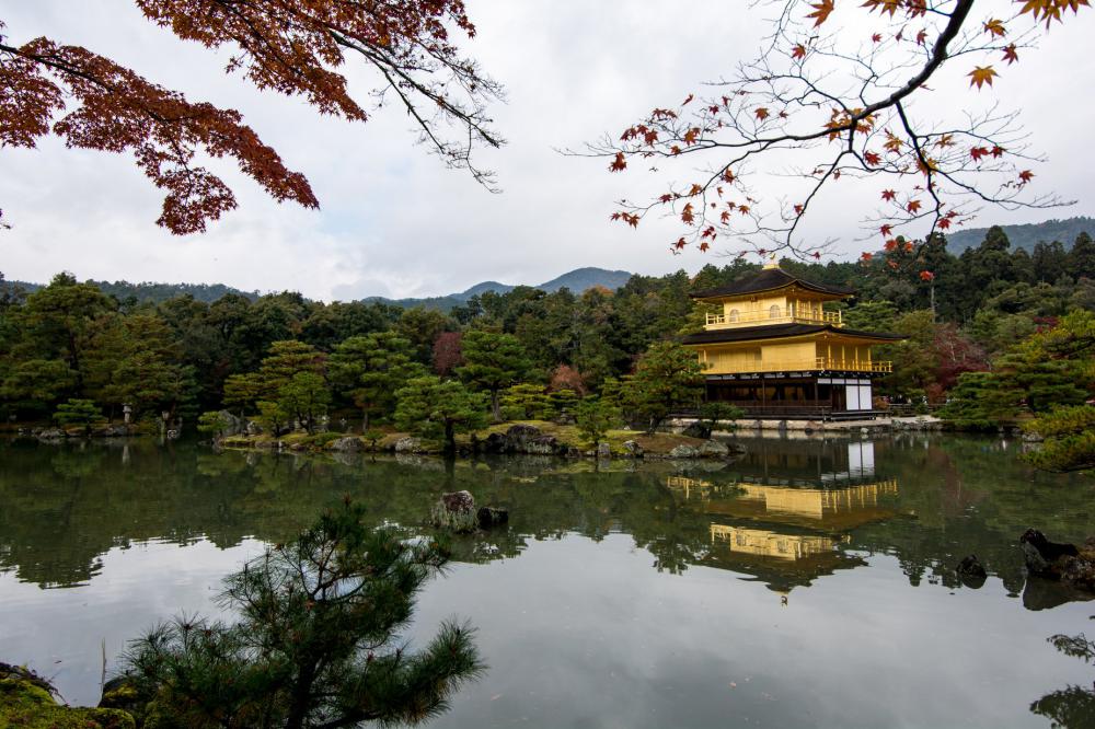 Yellow Building Sits On A Lake Surrounded By Trees Photo Yellow Building Sits On A Lake Surrounded By Trees Photo