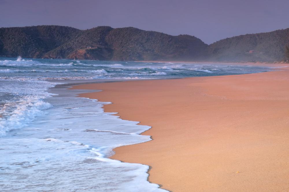 Waves Lap The Shore Of A Sandy Beach Photo Waves Lap The Shore Of A Sandy Beach Photo