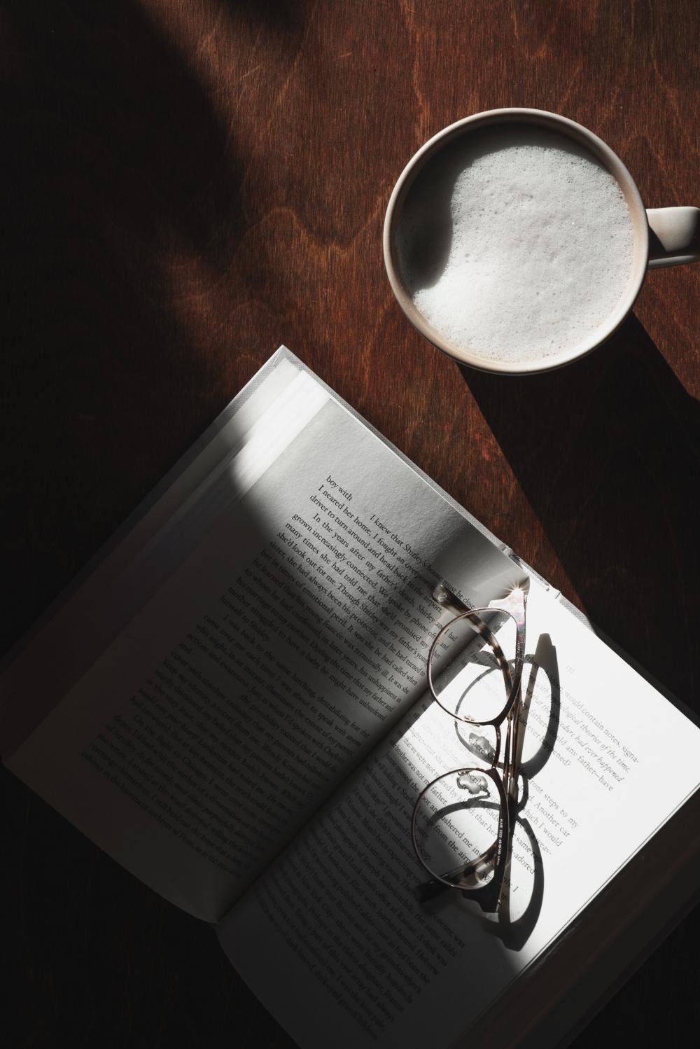 Wooden Table With Latte And Open Book With Glasses Photo Wooden Table With Latte And Open Book With Glasses Photo