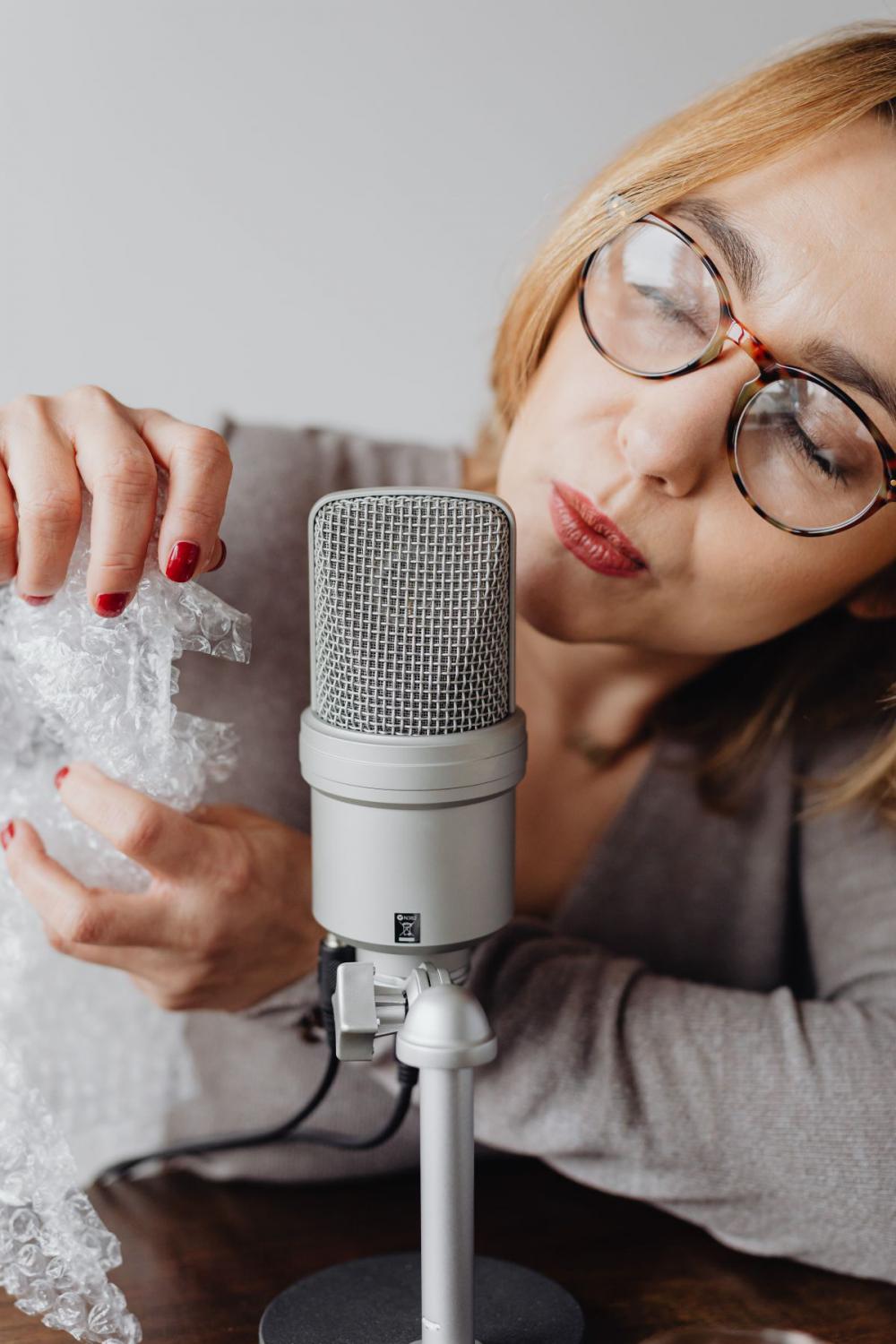 Woman Recording ASMR Sounds On Microphone Woman Recording ASMR Sounds On Microphone