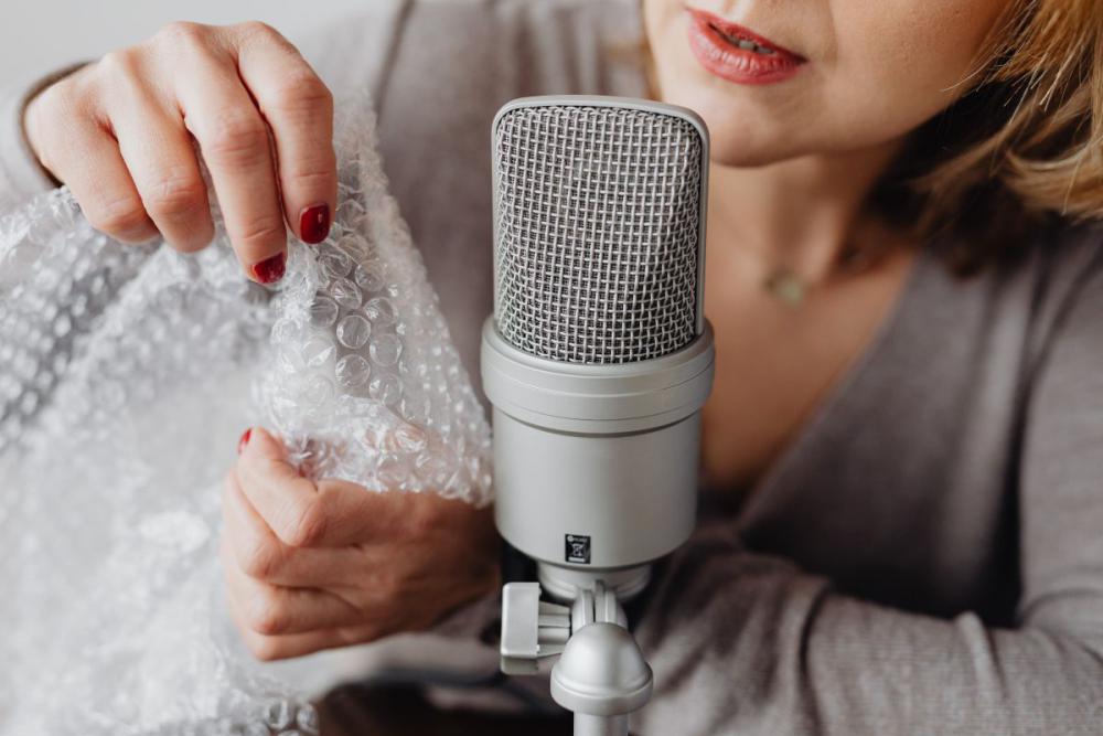 Woman Recording ASMR Sounds On Microphone Woman Recording ASMR Sounds On Microphone