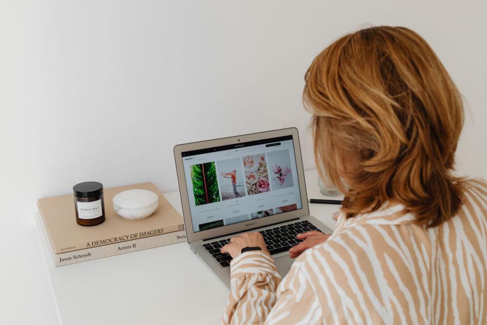 A woman works at her desk - home office A woman works at her desk - home office