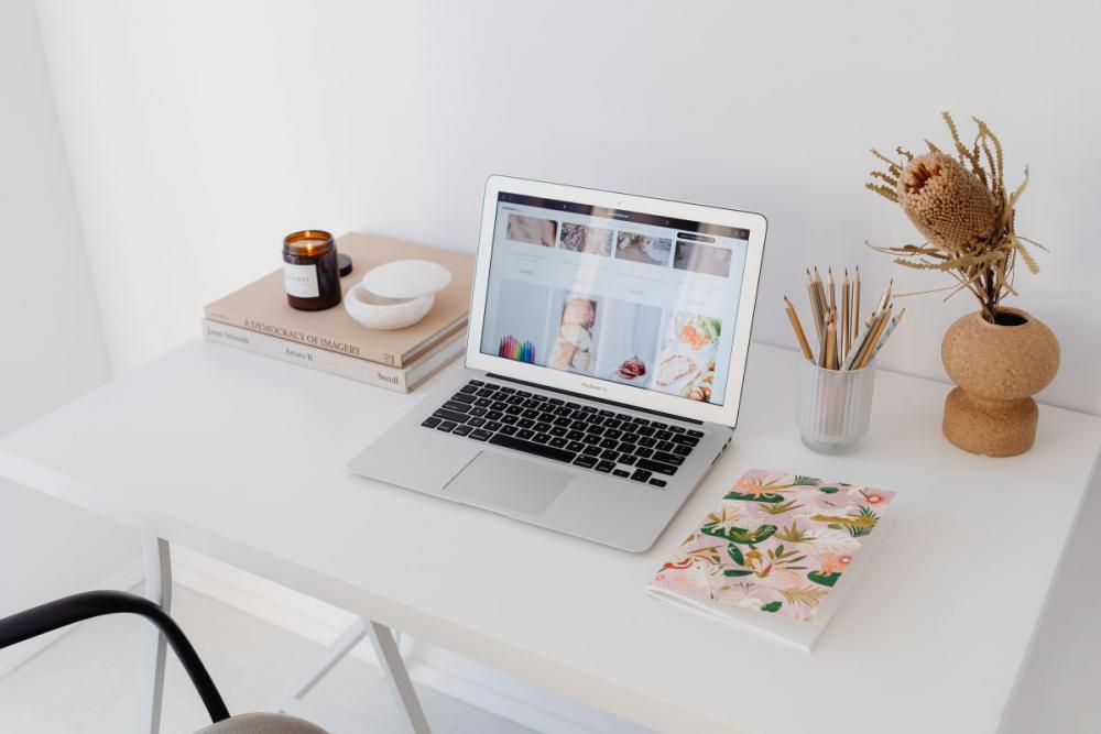 A woman works at her desk - home office A woman works at her desk - home office