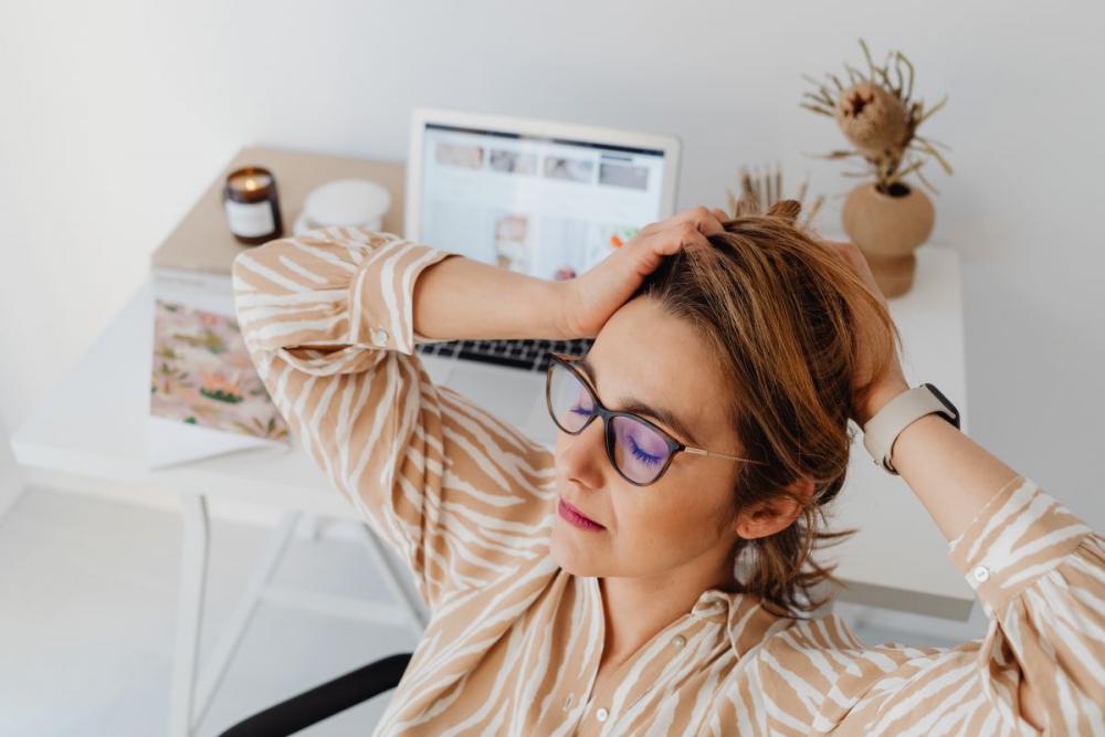 A woman works at her desk - home office A woman works at her desk - home office