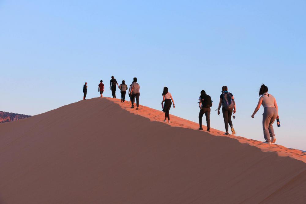 Tourists Hike Up Steep Sand Dune Photo Tourists Hike Up Steep Sand Dune Photo