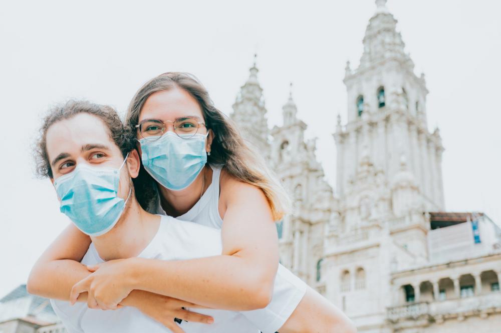 Woman Hugs Man While Wearing Blue Facemask Photo Woman Hugs Man While Wearing Blue Facemask Photo