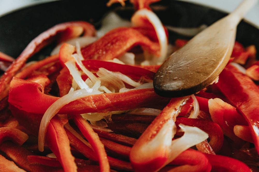 Close Up Of White Onions And Red Peppers Cooking In A Pan Photo Close Up Of White Onions And Red Peppers Cooking In A Pan Photo