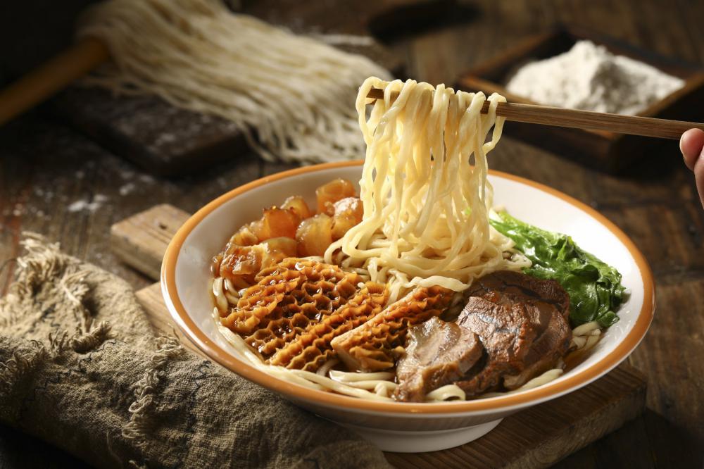 Chopsticks Held Over Bowl Of Hot Noodle Soup Photo Chopsticks Held Over Bowl Of Hot Noodle Soup Photo