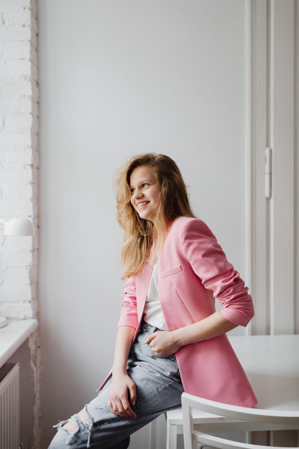 Beautiful teenage girl with long blonde hair wearing a pink jacket Beautiful teenage girl with long blonde hair wearing a pink jacket
