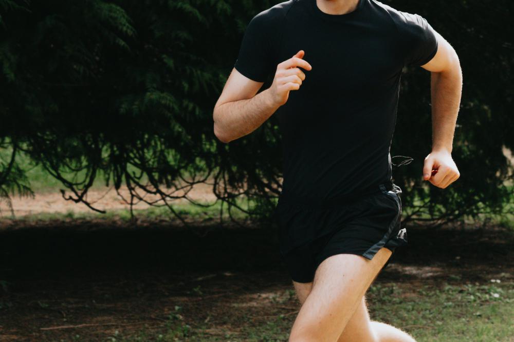 Person In Black Running In The Green Outdoors Photo Person In Black Running In The Green Outdoors Photo
