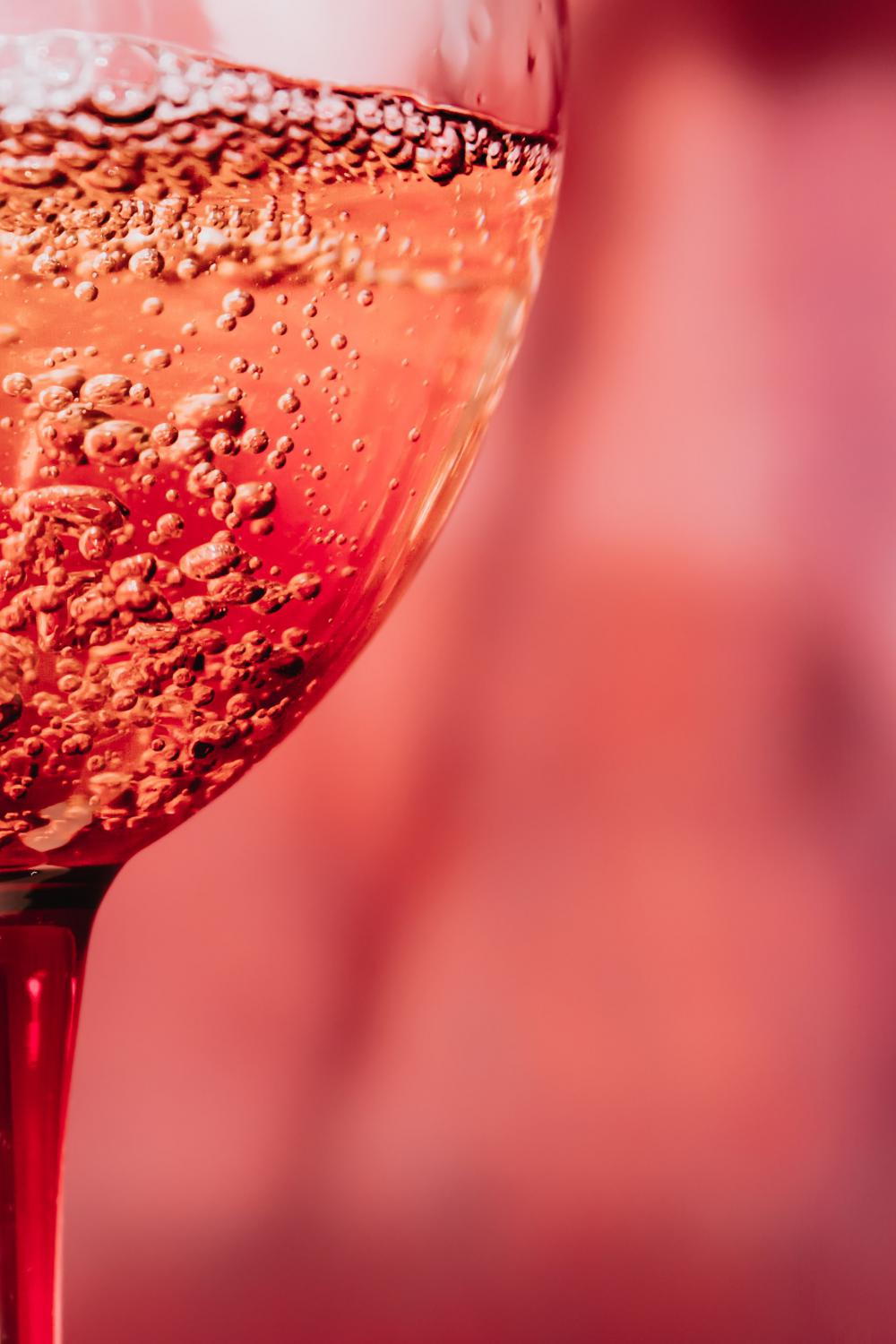 Close Up Of Bubbles In A Pink Glass Photo Close Up Of Bubbles In A Pink Glass Photo