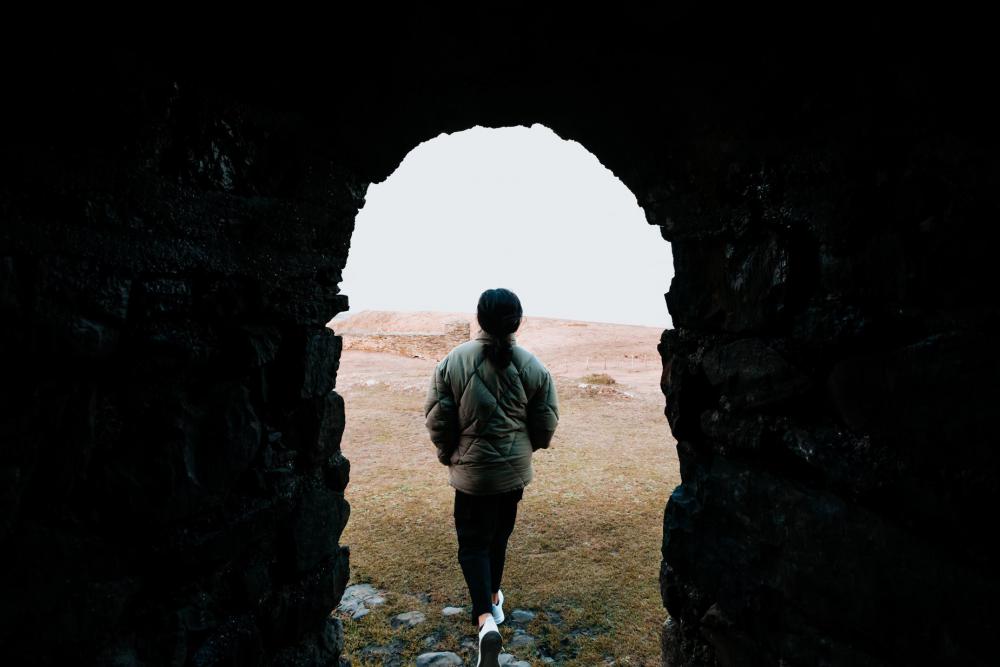 Stone Archway Frames A Person Walking To Beach Photo Stone Archway Frames A Person Walking To Beach Photo