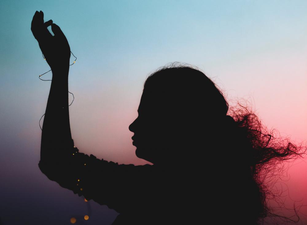Silhouetted Person Holding One Hand In Front Photo Silhouetted Person Holding One Hand In Front Photo