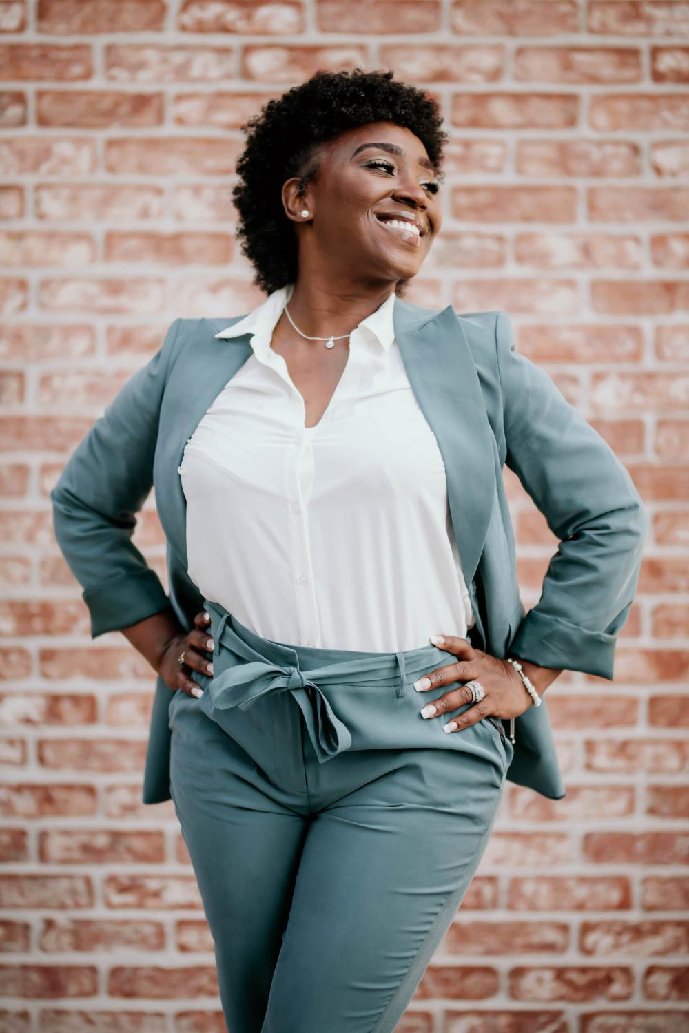 Woman In A Blue Suit Smiles And Poses For The Camera Photo Woman In A Blue Suit Smiles And Poses For The Camera Photo