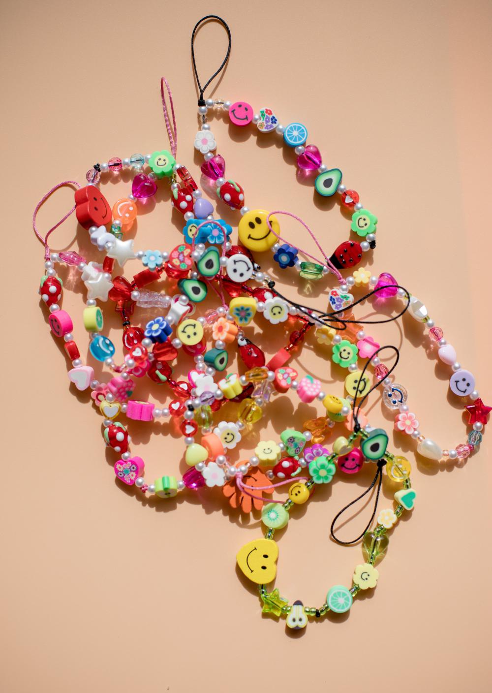 Colorful Beaded Bracelets On A Beige Background Photo Colorful Beaded Bracelets On A Beige Background Photo