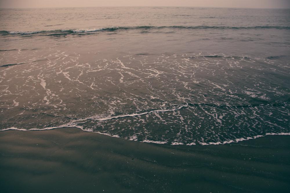 Waves Reaching The Wet Sand On Shore Photo Waves Reaching The Wet Sand On Shore Photo