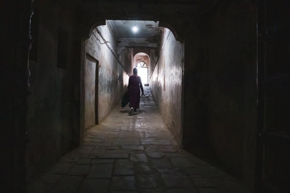 Silhouetted Person Walks Down A Tunnel Photo Silhouetted Person Walks Down A Tunnel Photo
