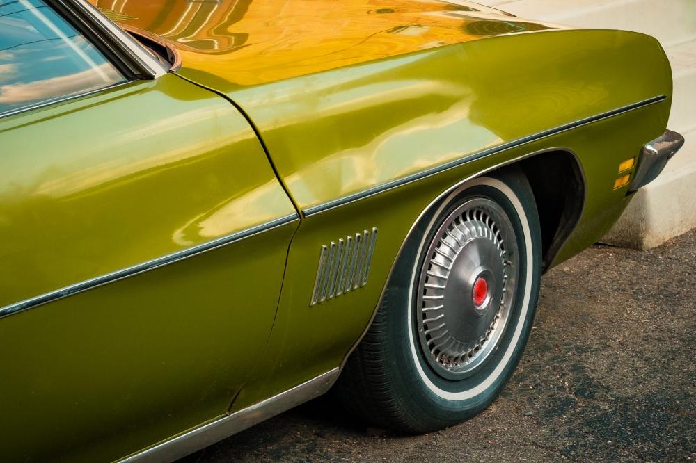 The Front Side Of An Olive Green Classic Car Photo The Front Side Of An Olive Green Classic Car Photo