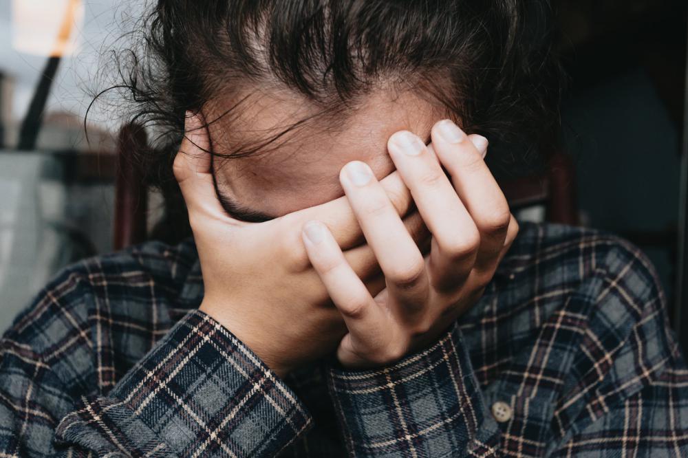 Person Holding Their Head In Their Hands Close Up Photo Person Holding Their Head In Their Hands Close Up Photo