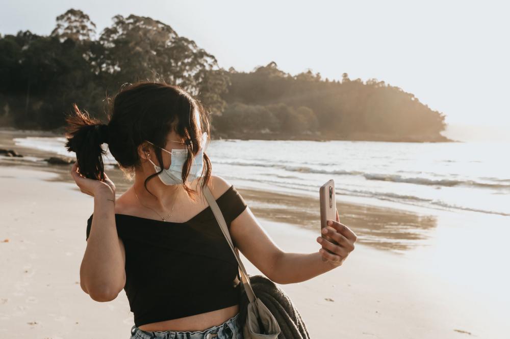 Woman In A Facemask Takes A Cellphone Selfie Photo Woman In A Facemask Takes A Cellphone Selfie Photo