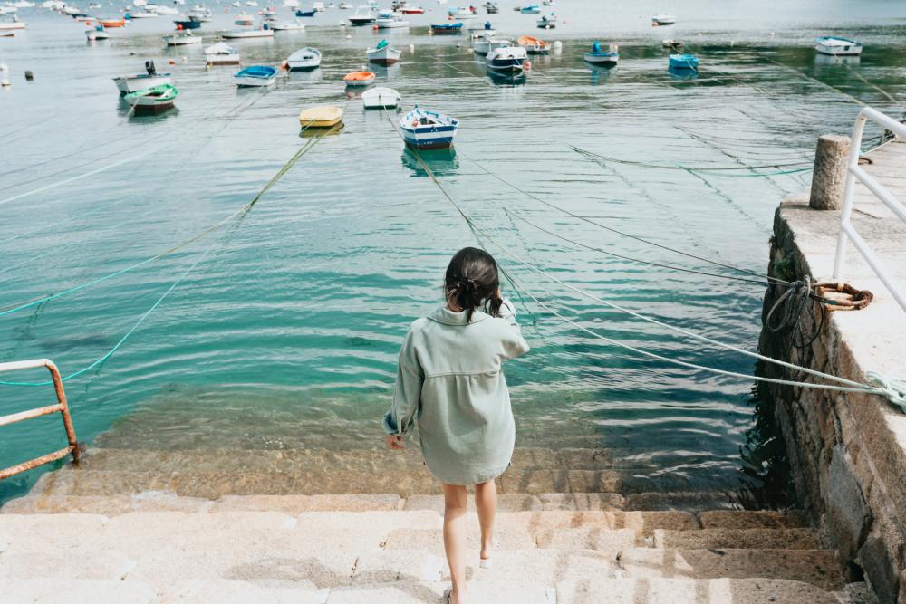 Person Walks Down Stone Steps Into Boat Filled Water Photo Person Walks Down Stone Steps Into Boat Filled Water Photo