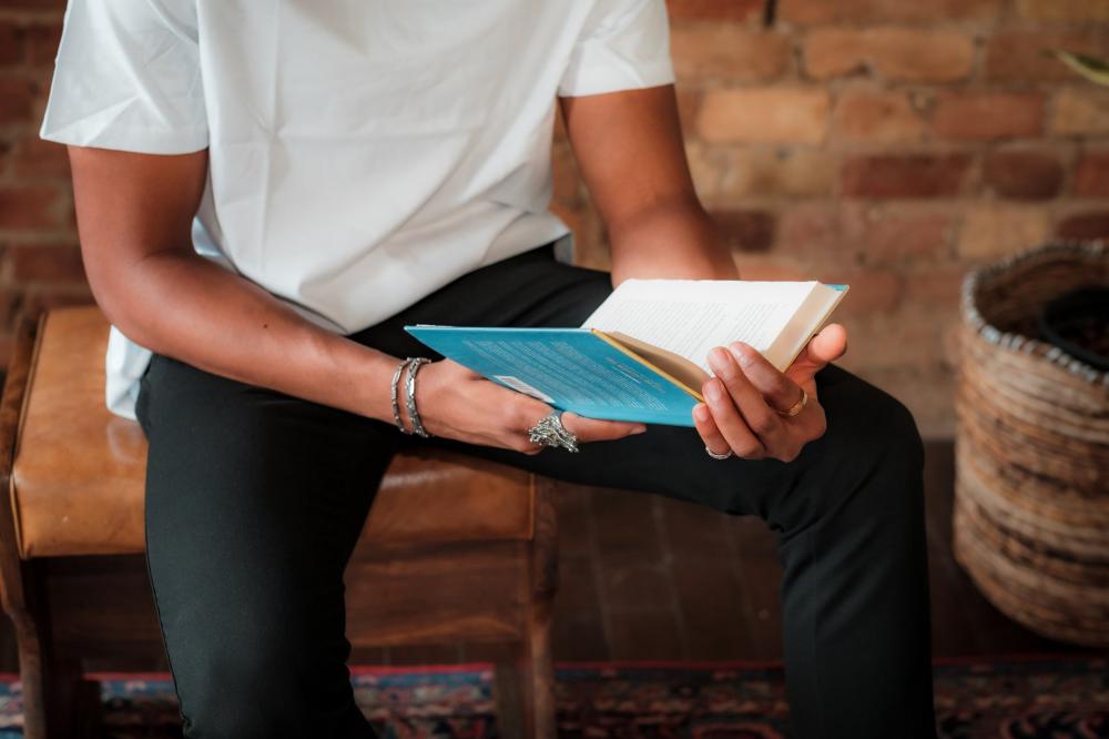 Torso Of A Person In White Shirt Reading A Novel Photo Torso Of A Person In White Shirt Reading A Novel Photo