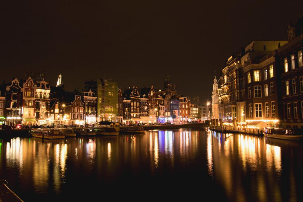 Waterside Town Lit Up At Night In Yellow Light Photo Waterside Town Lit Up At Night In Yellow Light Photo