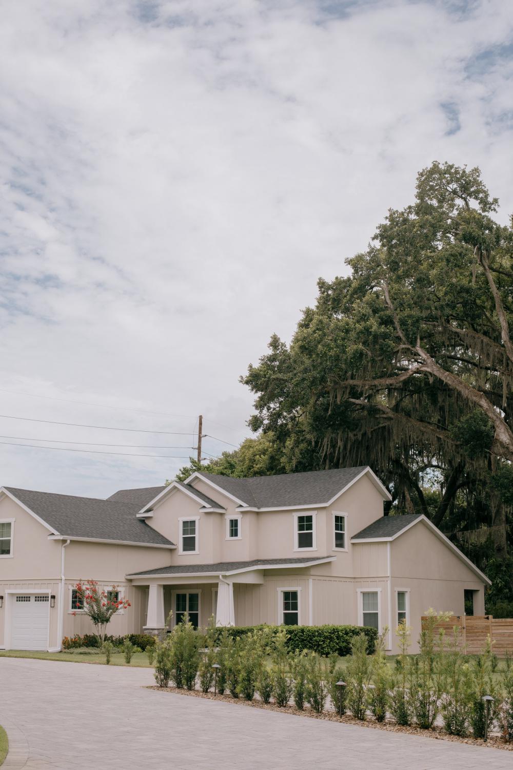 A Beige House With A Grey Roof And Large Trees Photo A Beige House With A Grey Roof And Large Trees Photo