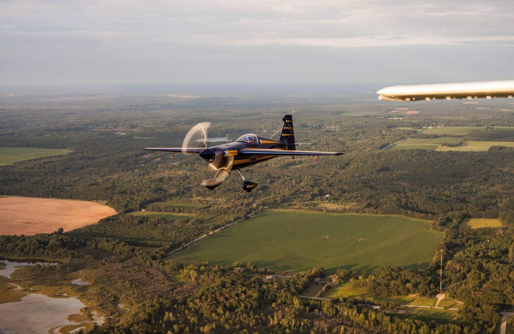 Blue And Yellow Aerobatic Plane In Flight Photo Blue And Yellow Aerobatic Plane In Flight Photo