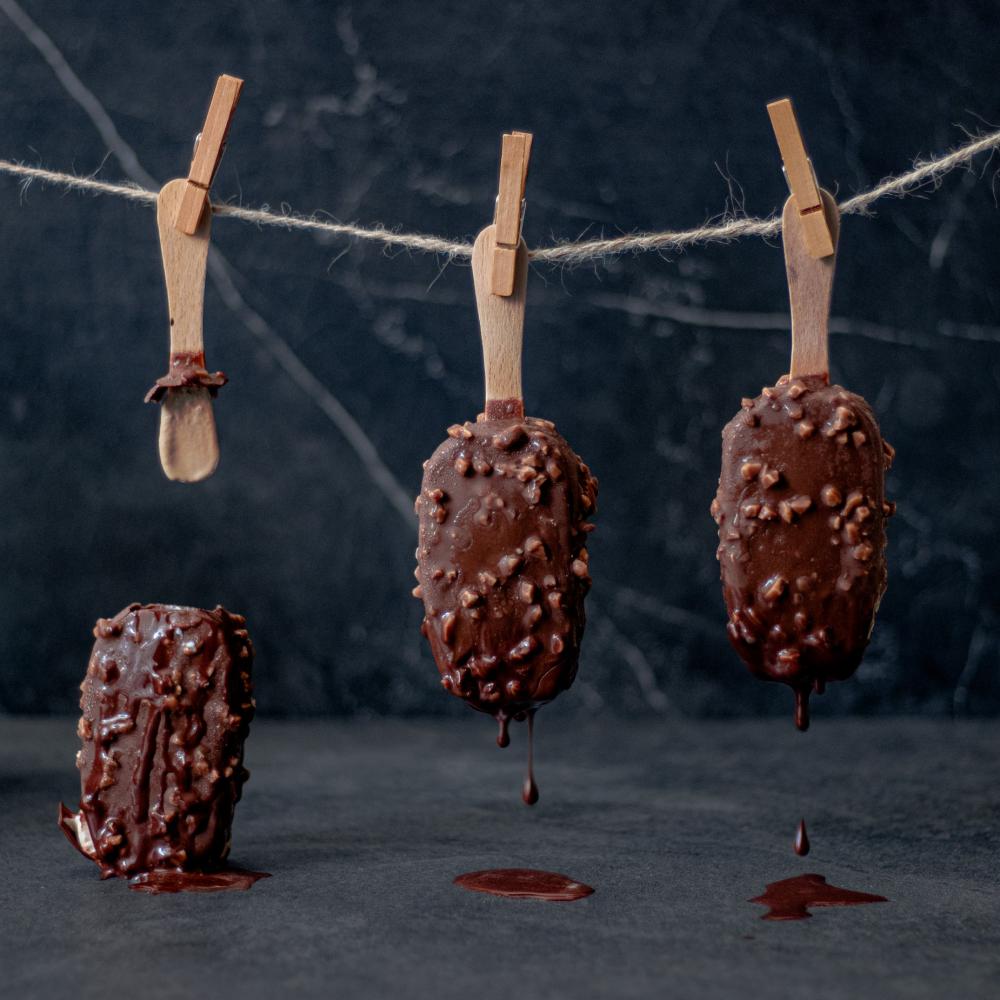 Three Ice Cream Bars Hang From Clothespins Upside Down Photo Three Ice Cream Bars Hang From Clothespins Upside Down Photo