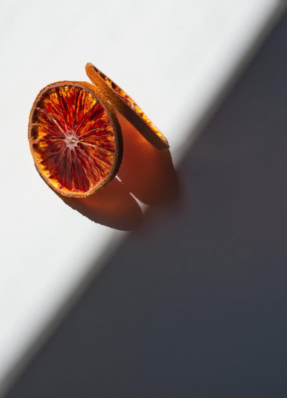 Dried Orange Slices Cast A Orange Shadow On White Photo Dried Orange Slices Cast A Orange Shadow On White Photo