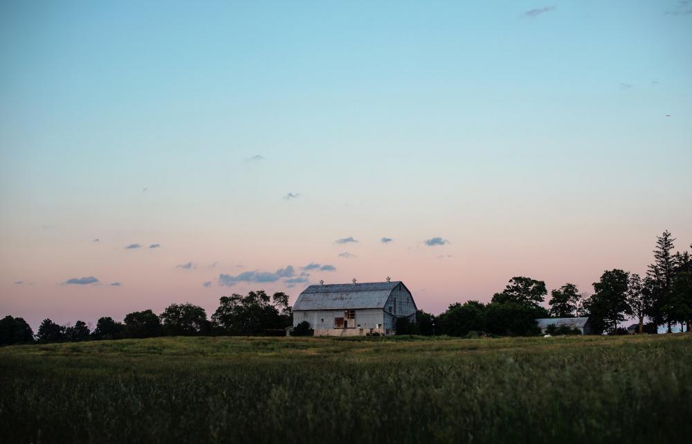Large Blue Barn In The Countryside At Sunset Photo Large Blue Barn In The Countryside At Sunset Photo