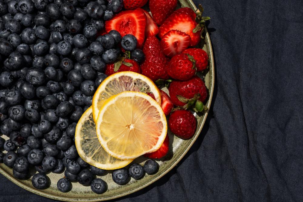 Summer Fruits On A Green Plate With A Blue Tablecloth Photo Summer Fruits On A Green Plate With A Blue Tablecloth Photo
