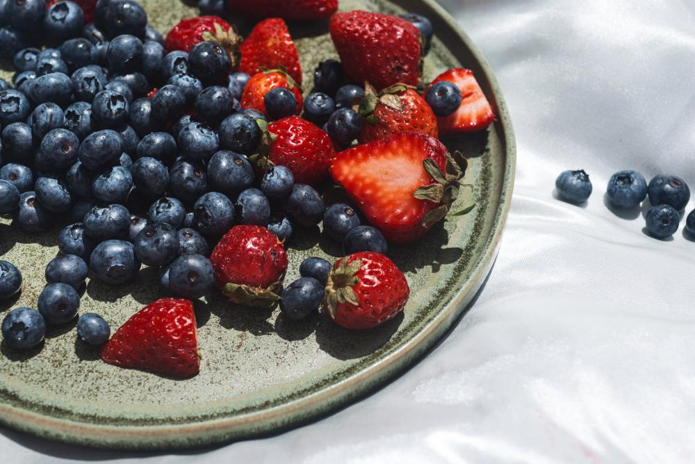 Green Plate With Fresh Berries On Silk Photo Green Plate With Fresh Berries On Silk Photo