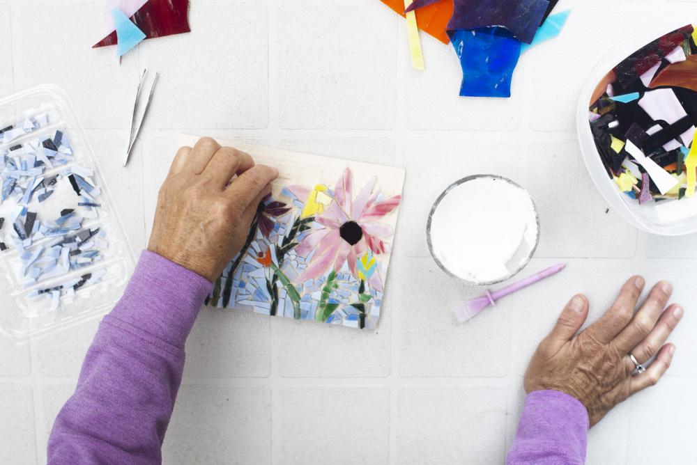 Hands Working On A Floral Mosaic On A Grey Table Photo Hands Working On A Floral Mosaic On A Grey Table Photo
