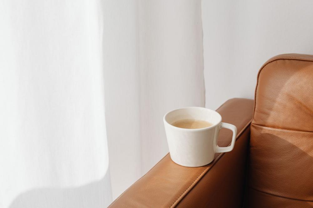 A cup of coffee and a leather sofa A cup of coffee and a leather sofa