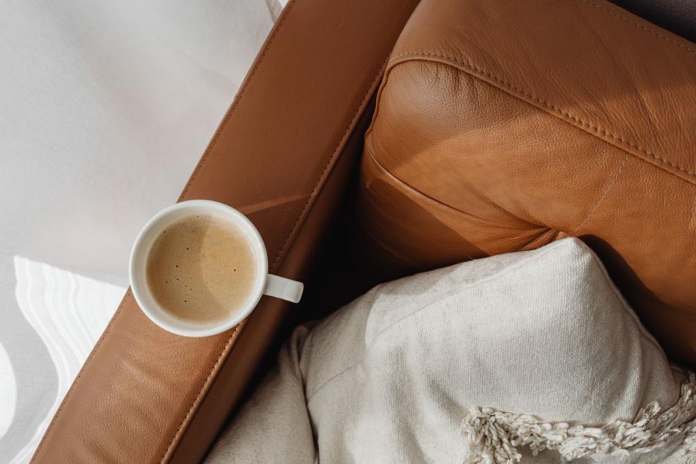 A cup of coffee and a leather sofa A cup of coffee and a leather sofa