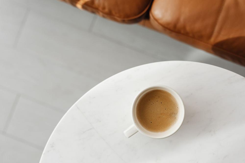 A cup of coffee and a leather sofa A cup of coffee and a leather sofa