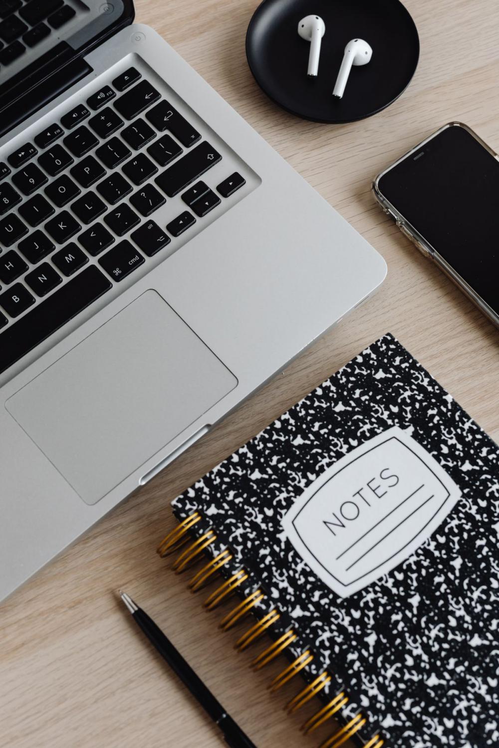Workspace - laptop - AirPods - desk - notebooks - mobile phone Workspace - laptop - AirPods - desk - notebooks - mobile phone