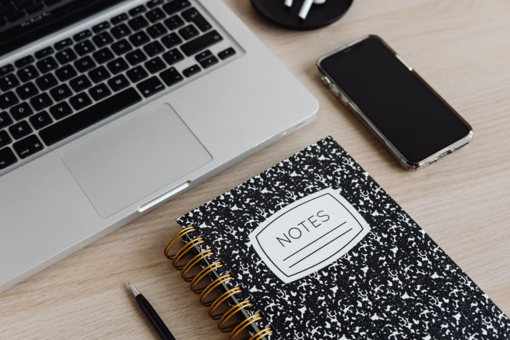 Workspace - laptop - AirPods - desk - notebooks - mobile phone Workspace - laptop - AirPods - desk - notebooks - mobile phone