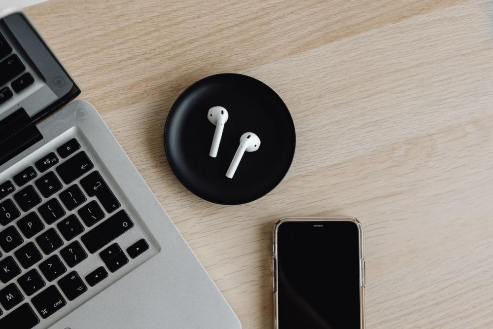 Workspace - laptop - AirPods - desk - notebooks - mobile phone Workspace - laptop - AirPods - desk - notebooks - mobile phone
