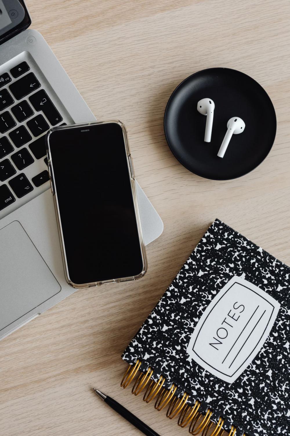 Workspace - laptop - AirPods - desk - notebooks - mobile phone Workspace - laptop - AirPods - desk - notebooks - mobile phone