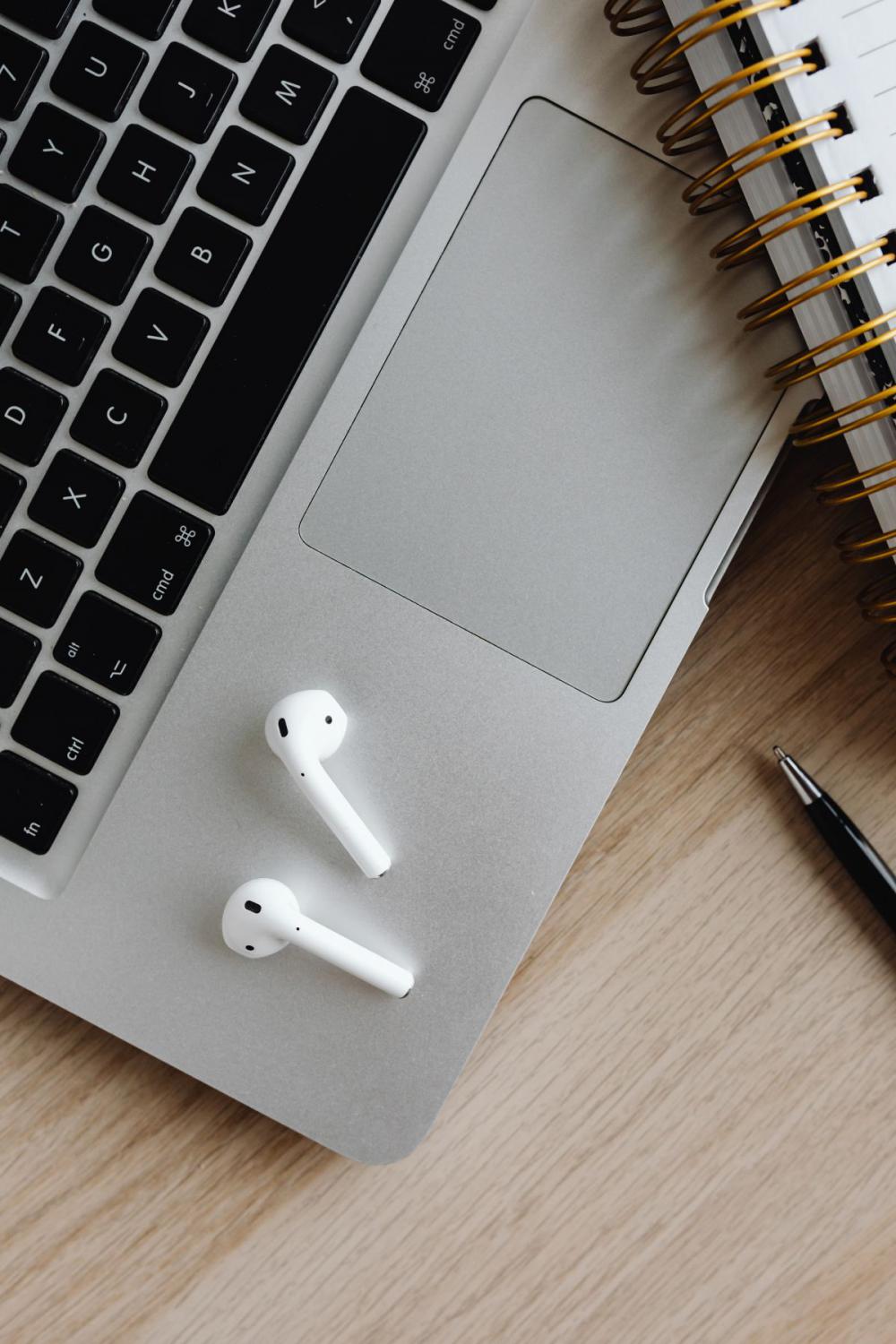 Workspace - laptop - AirPods - desk - notebooks - mobile phone Workspace - laptop - AirPods - desk - notebooks - mobile phone
