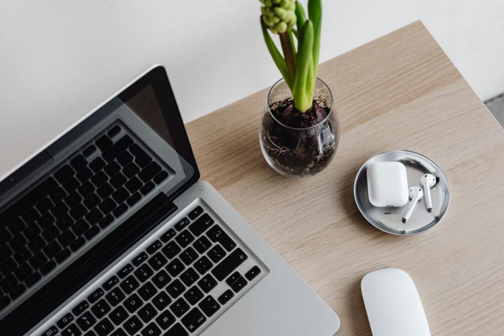 Workspace - laptop - AirPods - desk - notebooks - mobile phone Workspace - laptop - AirPods - desk - notebooks - mobile phone