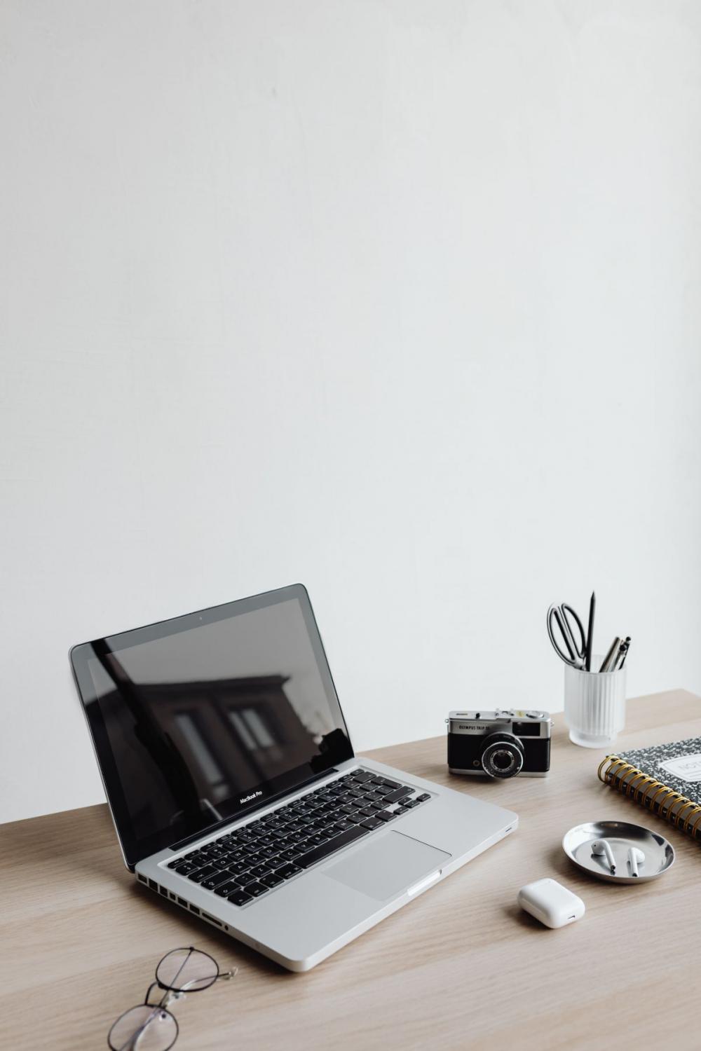 Workspace - laptop - AirPods - desk - notebooks - mobile phone Workspace - laptop - AirPods - desk - notebooks - mobile phone