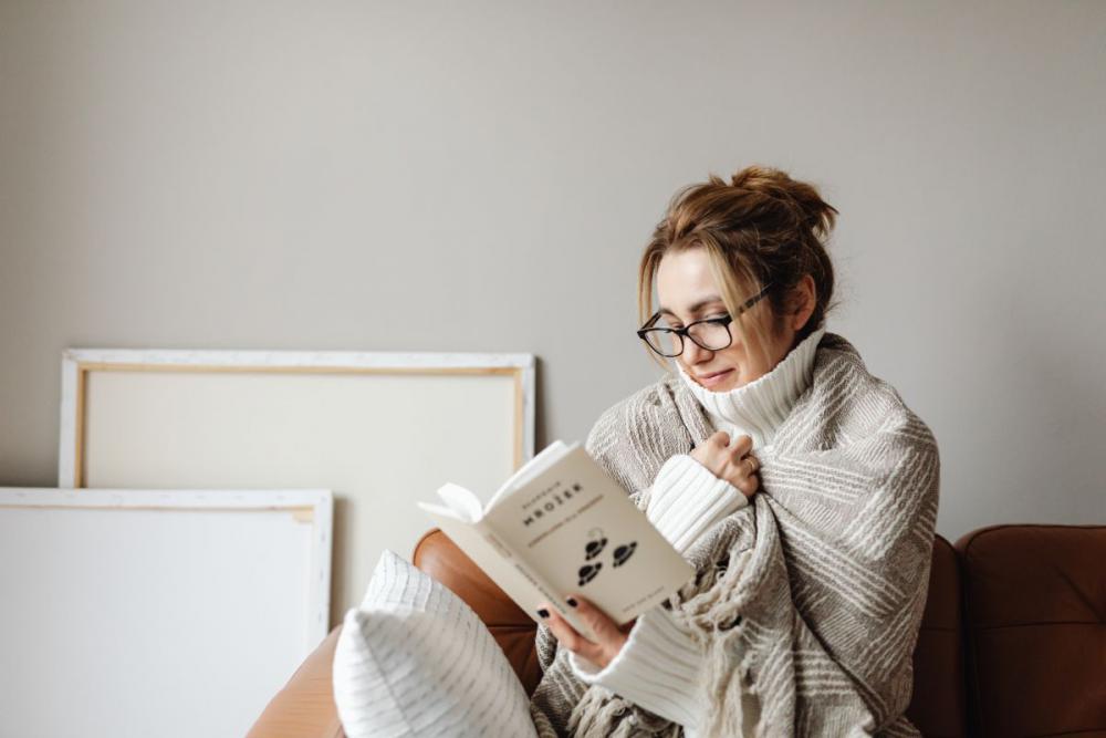 Cocooning - isolating yourself - stay at home - woman under blanket Cocooning - isolating yourself - stay at home - woman under blanket