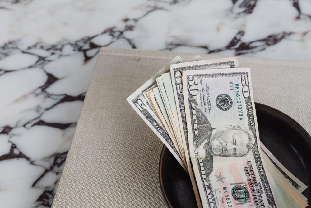 Dollar bills on a marble table Dollar bills on a marble table