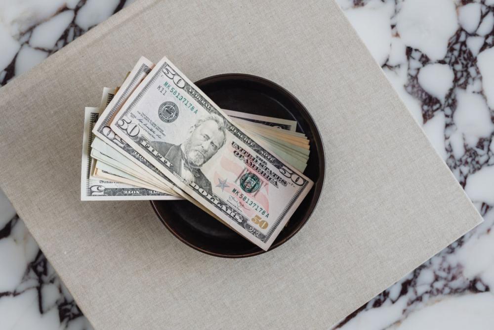 Dollar bills on a marble table Dollar bills on a marble table