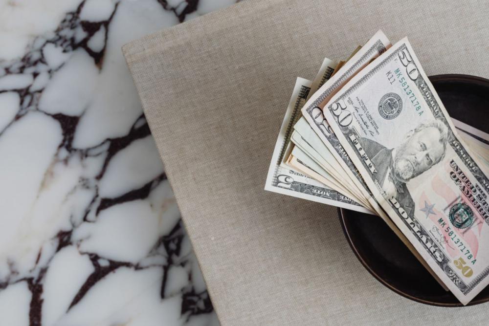 Dollar bills on a marble table Dollar bills on a marble table