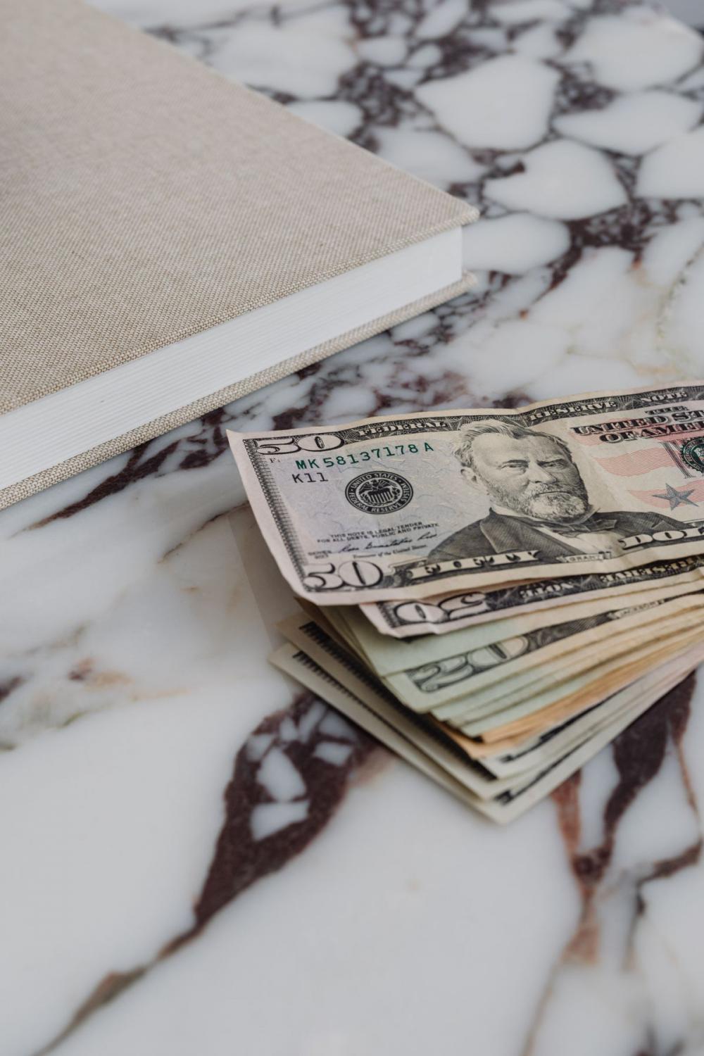 Dollar bills on a marble table Dollar bills on a marble table
